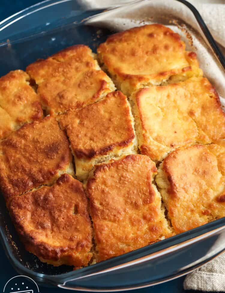 a square glass pan of butter swim biscuits cut into 9 servings.