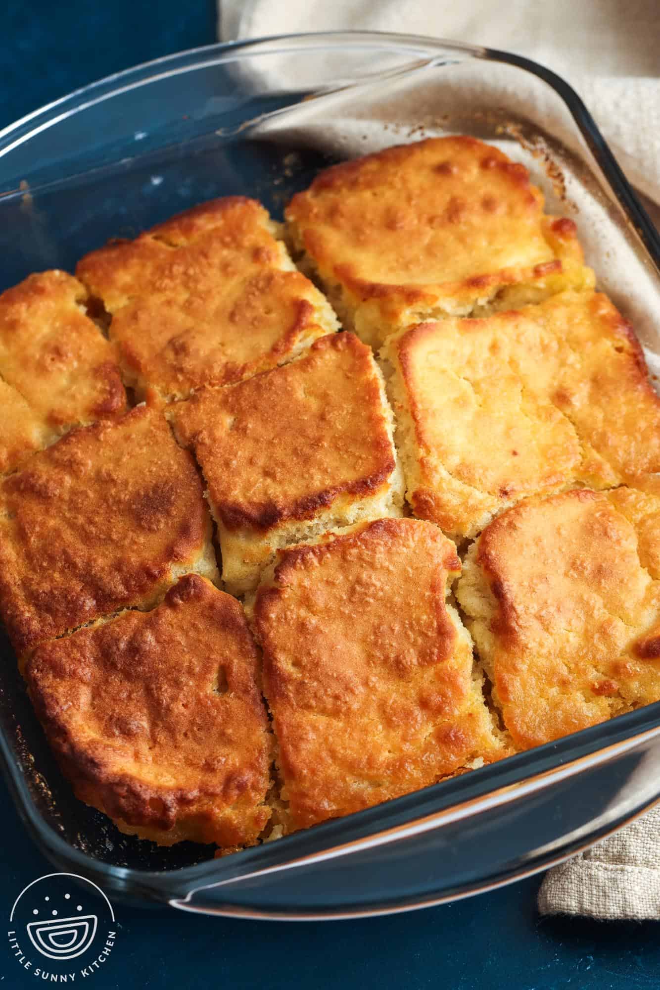 a square glass pan of butter swim biscuits cut into 9 servings.