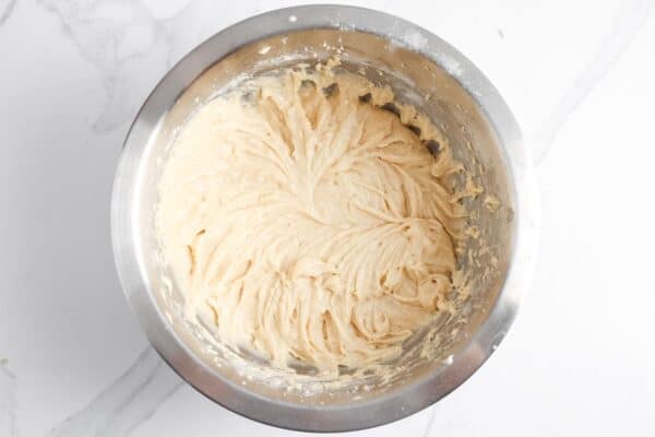 cinnamon roll muffin batter in a metal mixing bowl.