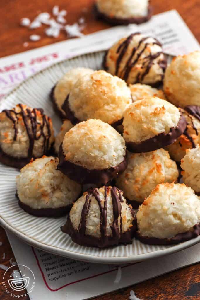 a plate of coconut macaroons on top of a newspaper.