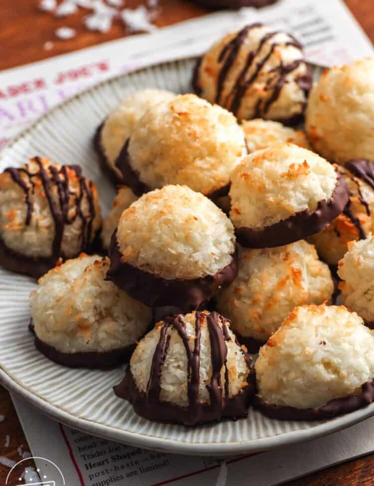 a plate of coconut macaroons on top of a newspaper.