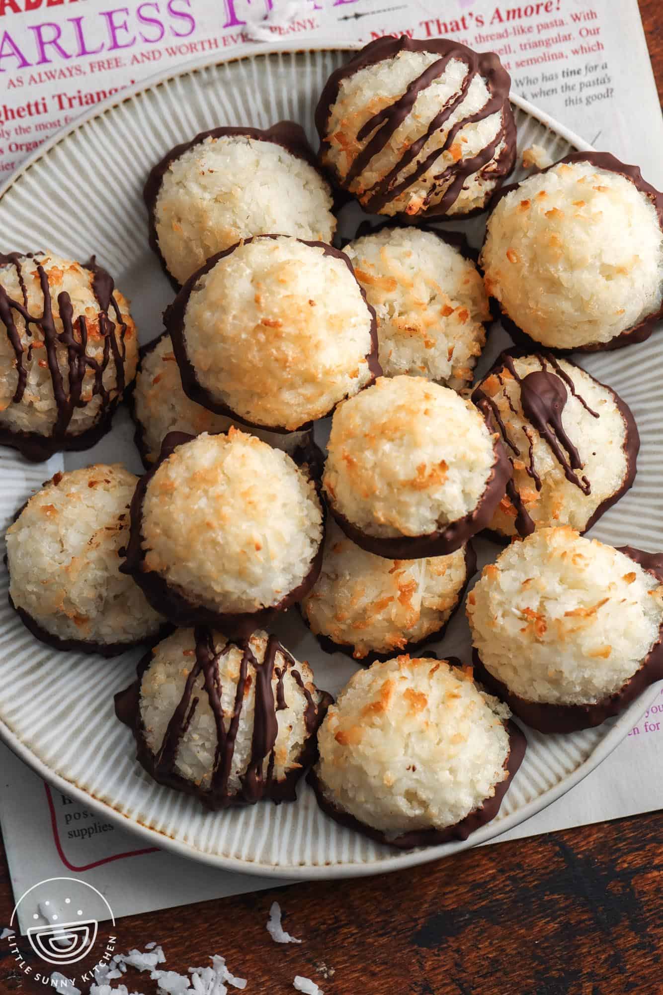 overhead view of a platter of coconut macaroon cookies sitting on top of a trader joes newsletter.