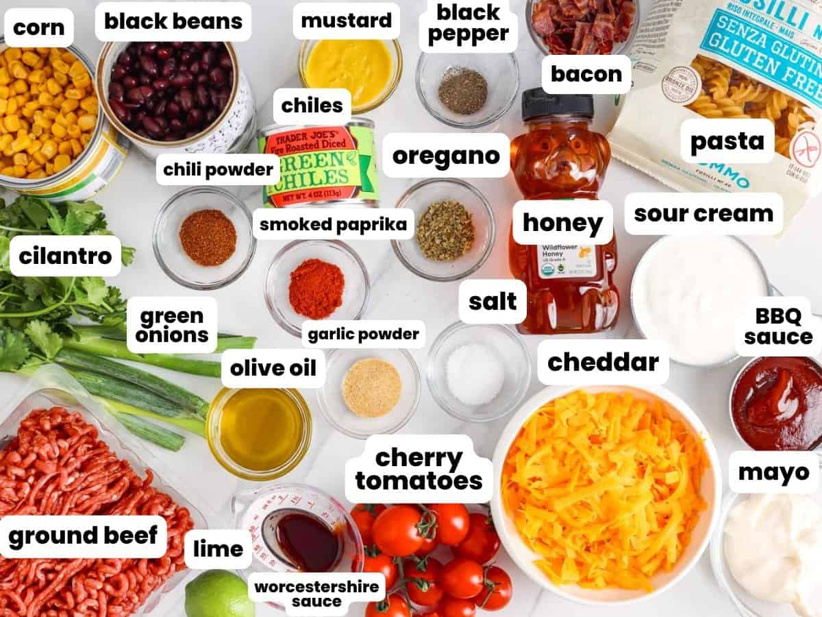 Ingredients for cowboy pasta salad with ground beef, beans, corn, bacon, and bbq sauce.