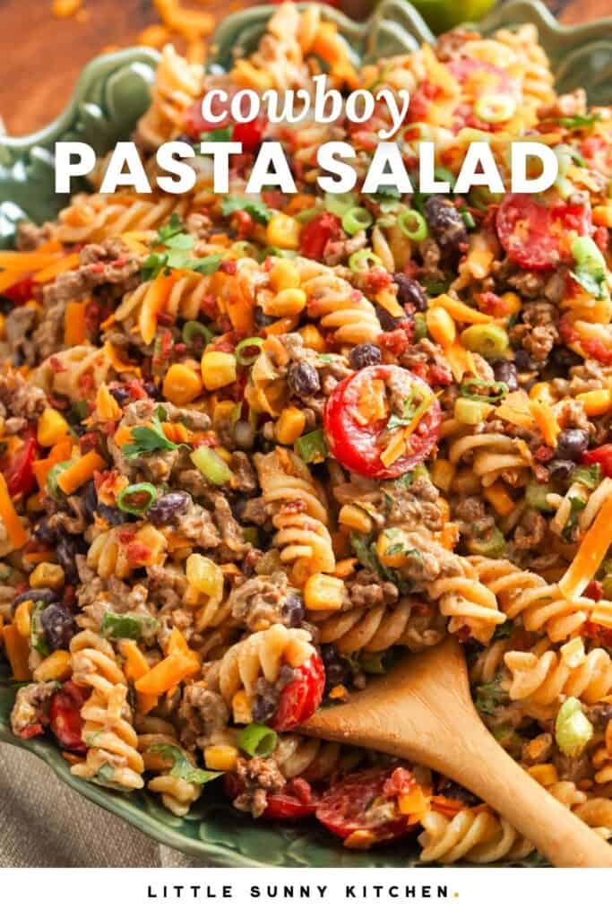 a bowl of pasta salad with beef, beans, and corn. Text overlay reads, "cowboy pasta salad"