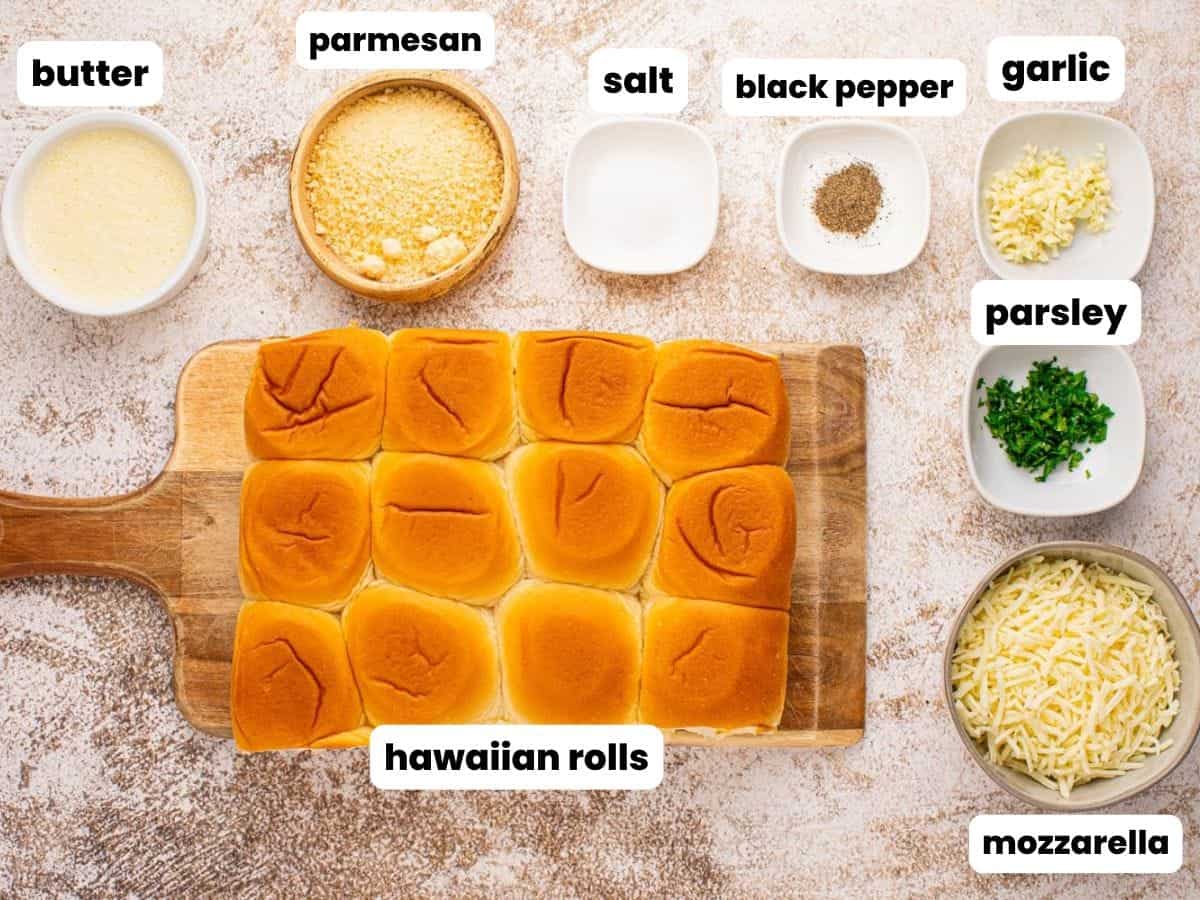 a package of hawaiian rolls along with cheese butter and seasonings to turn them into garlic bread.