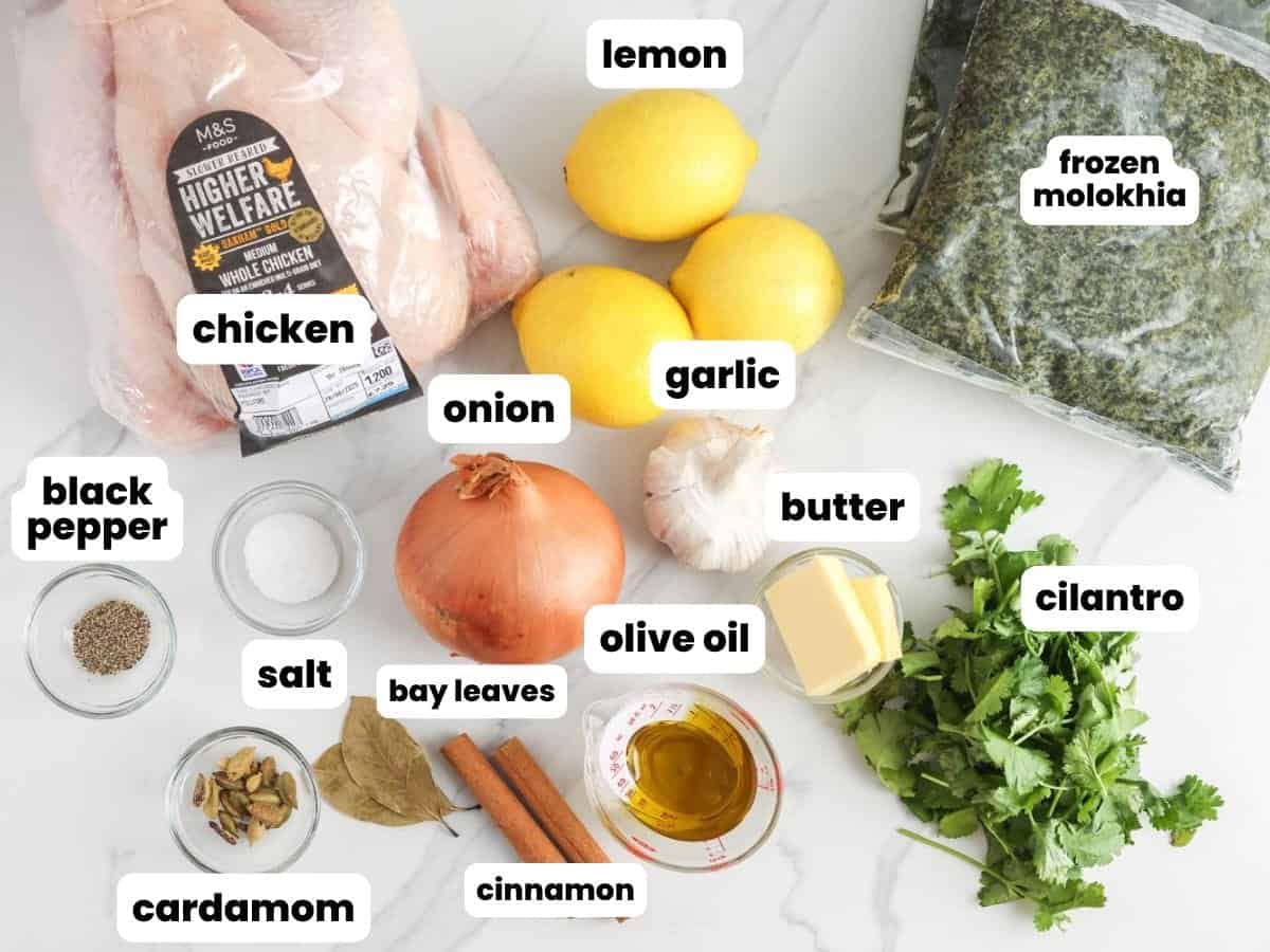 Ingredients for molokhia stew made with a whole chicken, frozen molokhia (jute leaves), lemon, and seasonings.
