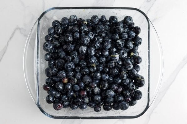 fresh berries coated with sugar, cornstarch, and lemon juice to make blueberry crisp.