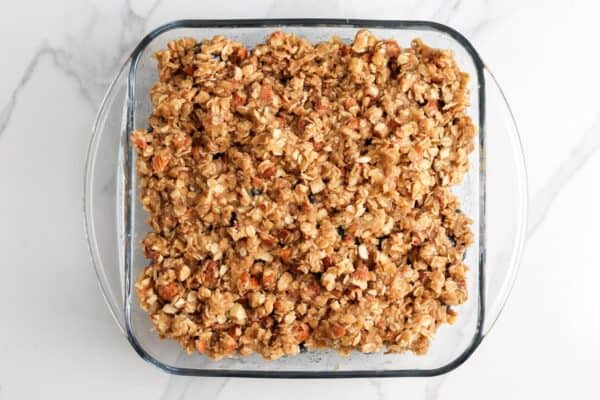 Blueberry crisp in a square baking dish, ready to bake.