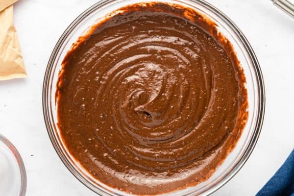 Prepared chocolate pudding mixture in a clear bowl.