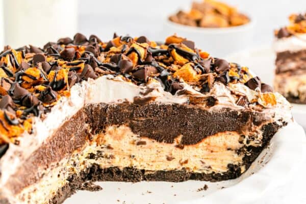 Finished pie sliced open to show clean layers of crust, filling, pudding, and toppings.