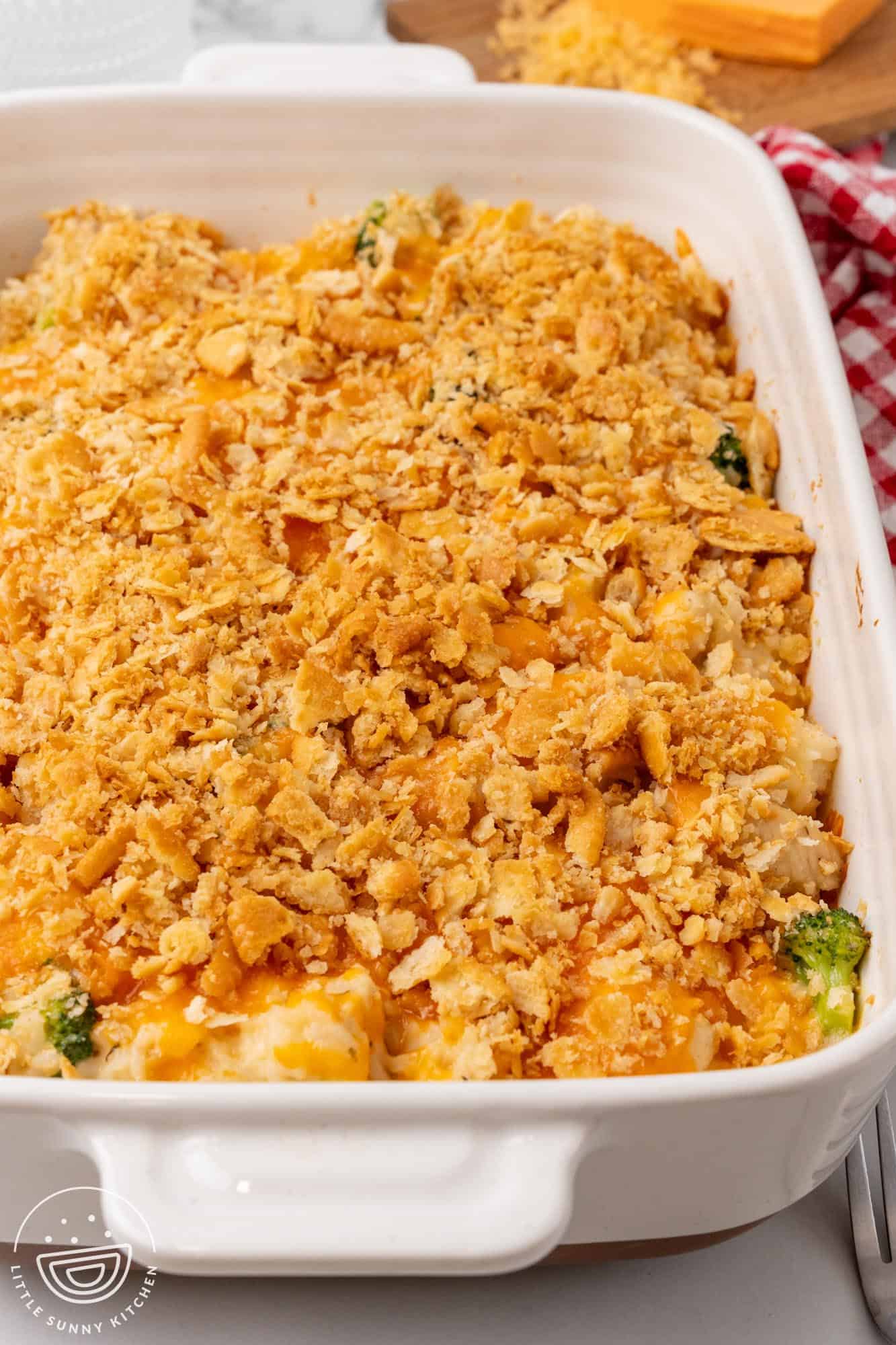 a casserole pan of chicken broccoli rice and cheese casserole on a counter.