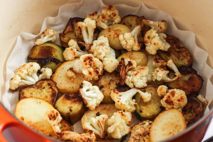 fried cauliflower pieces, potato slices, and eggplant slices draining on paper towels.
