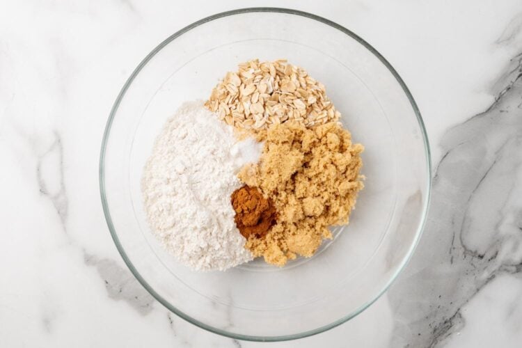 oats, flour, sugar, and cinnamon in a large glass bowl.