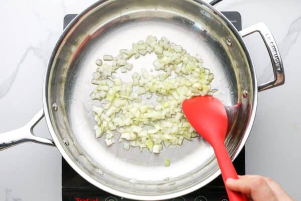 diced onions sauteed in a stainless steel skillet.