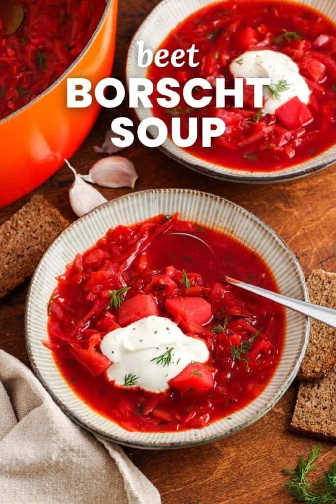 Two bowls of red borscht soup on a wooden table. Text overlay says "beet borscht soup"