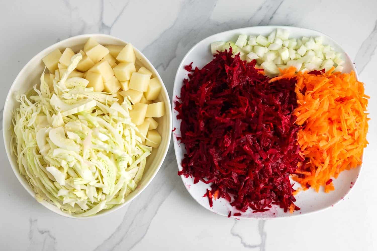 shredded vegetables for borscht soup on two plates. 