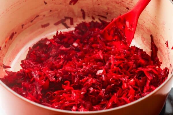 grated carrots cooked with grated beets in a dutch oven.