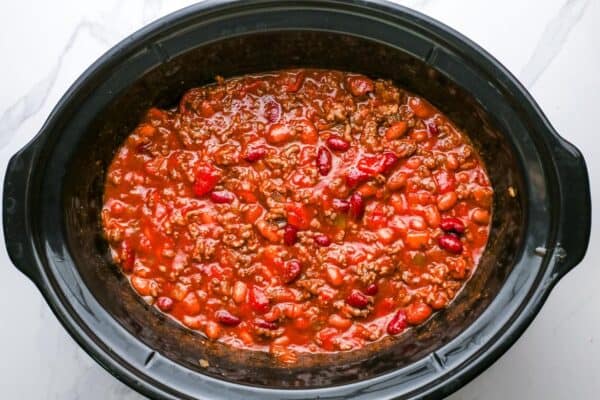 chili ingredients mixed together in a crock pot, before cooking.