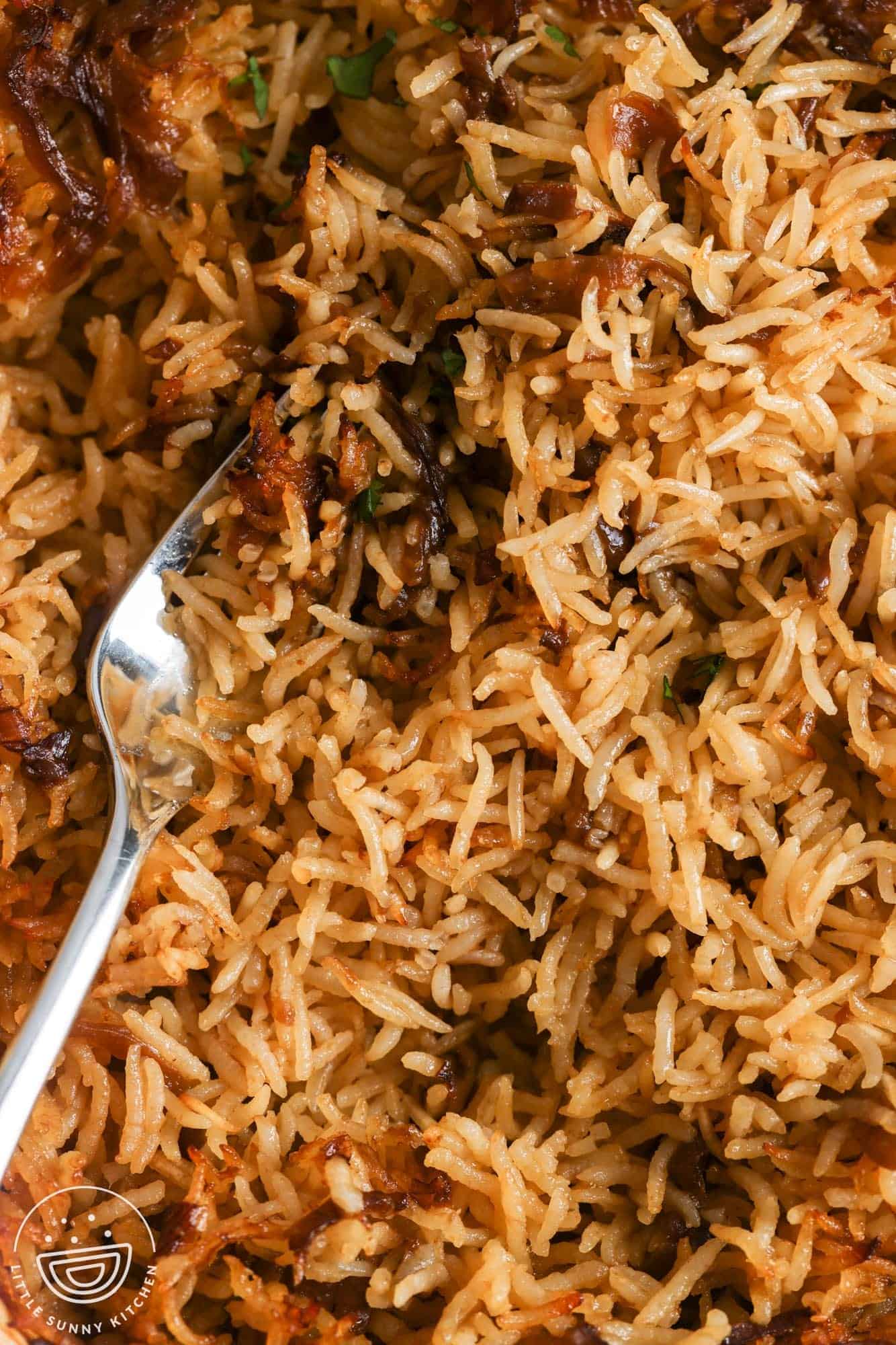 closeup of baked stick of butter rice, showing the caramelized onions and fluffy rice.