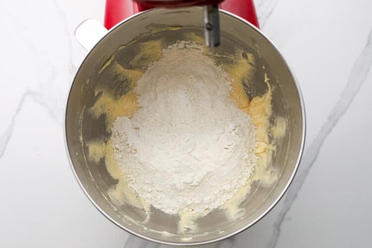 dry ingredients added to wet ingredients for cake batter, in the bowl of a stand mixer.