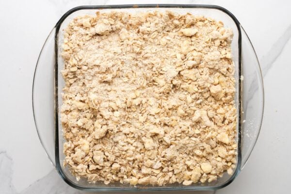 Apple crisp in a square baking pan ready to be baked.