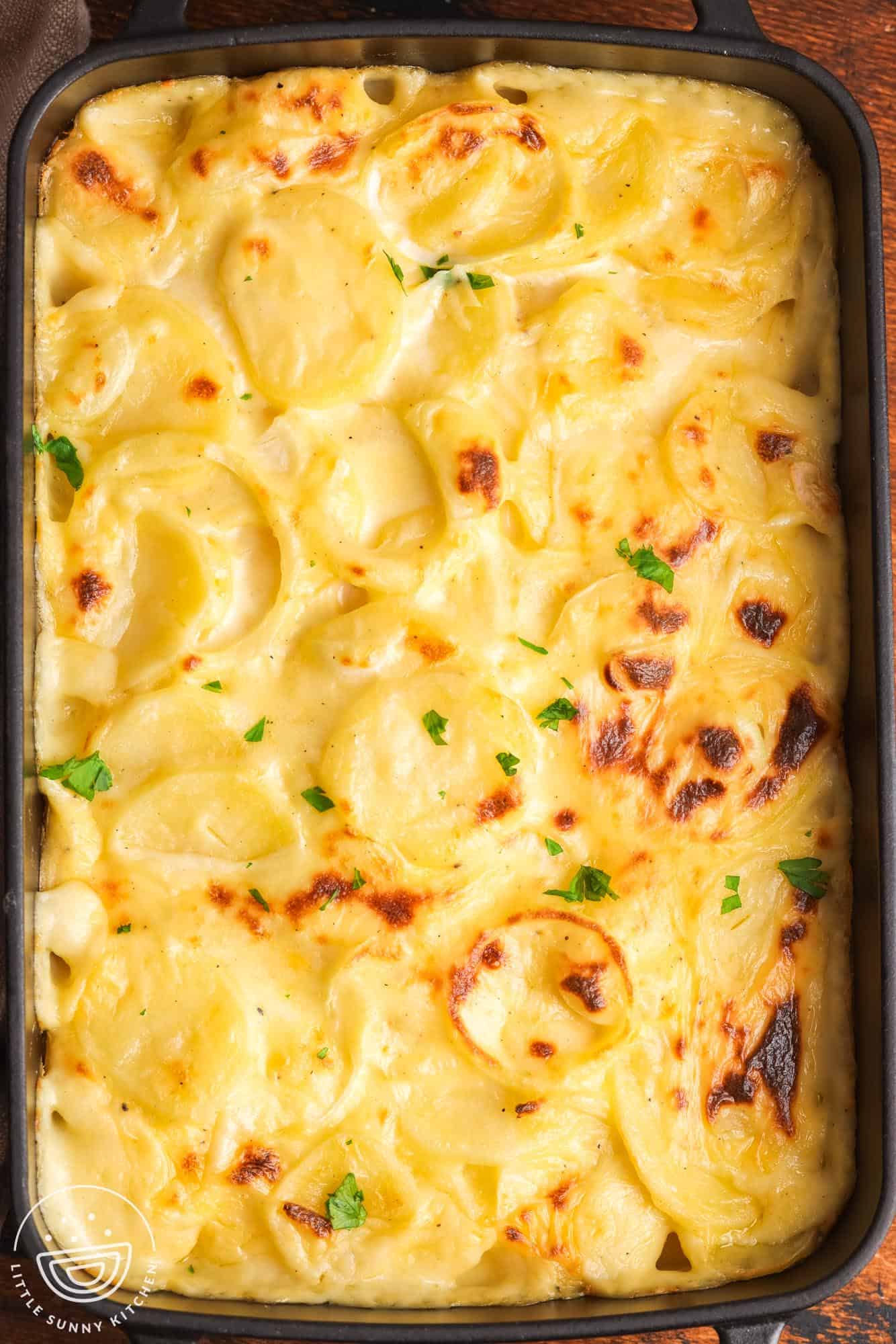 overhead view of a pan of homemade cheesy scalloped potatoes.