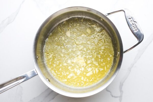 garlic cooking in melted butter in a medium saucepan.