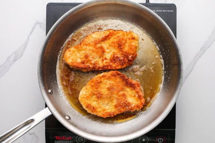 fried chicken cutlets in a frying pan.