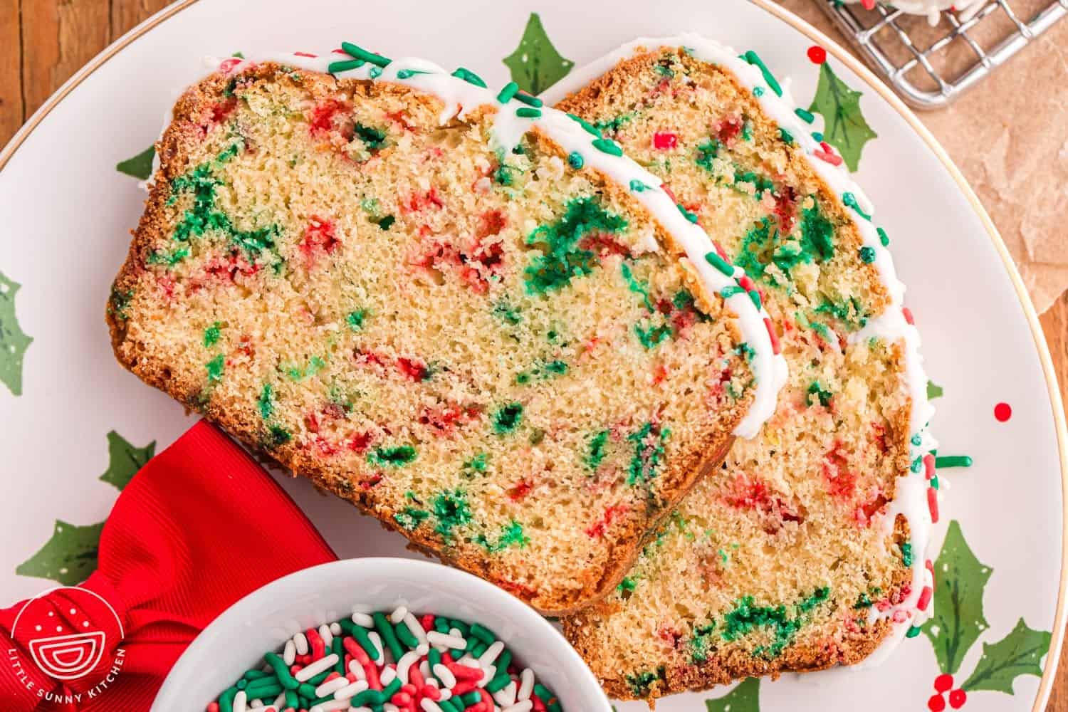 two slices of sweet bread with red and green christmas sprinkles on a plate.