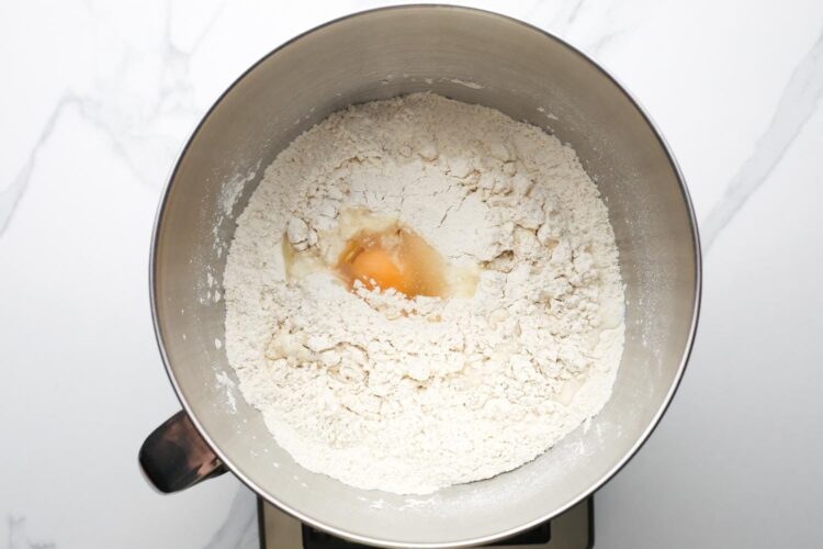 Egg added to flour mixture for enriched crescent roll dough.