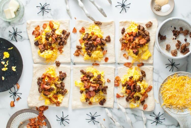 Dough rectangles filled with scrambled eggs, sausage crumbles, and chopped bacon.