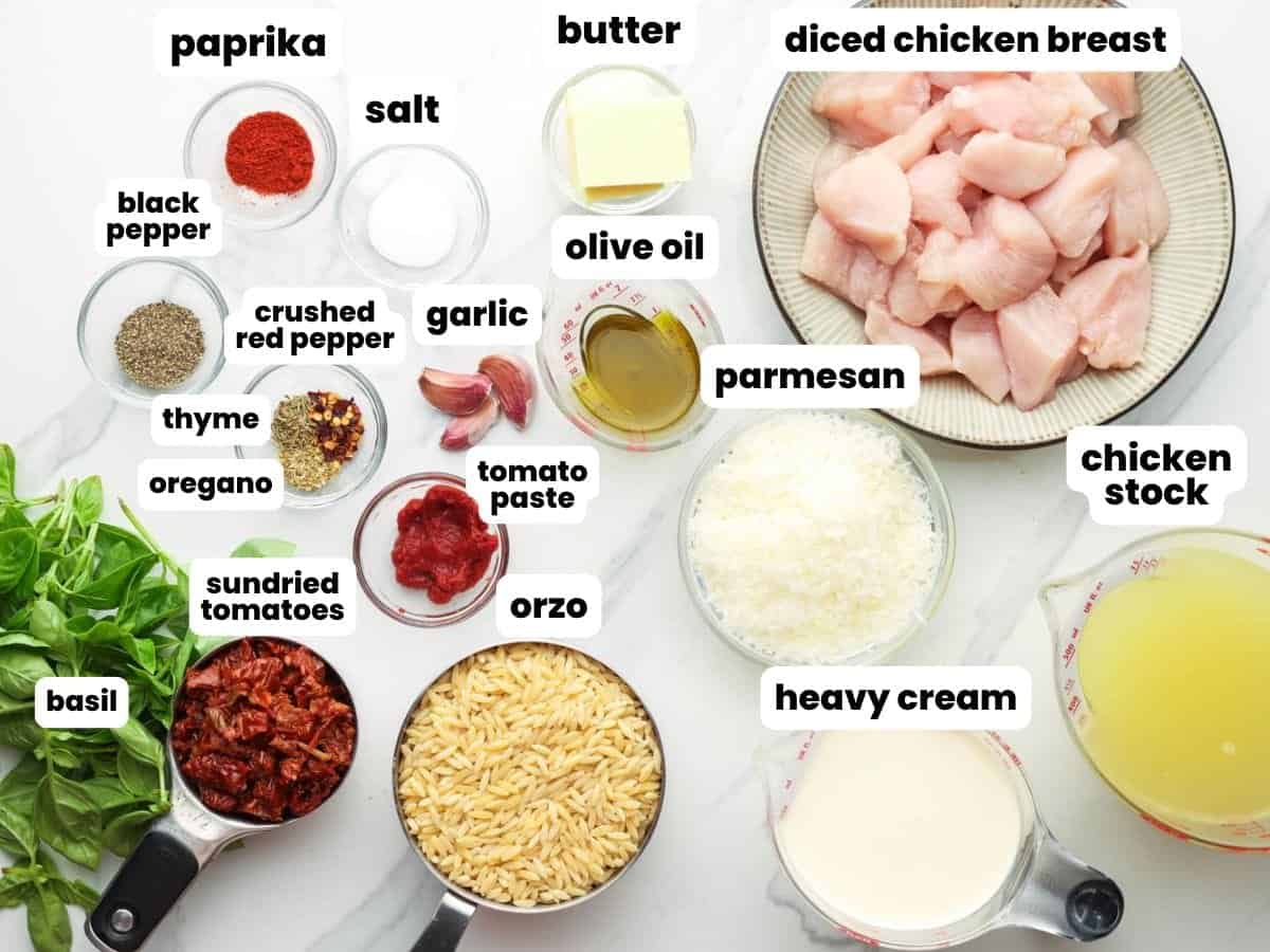 Ingredients for Marry Me Chicken Orzo, including sundried tomatoes, heavy cream, and parmesan cheese.