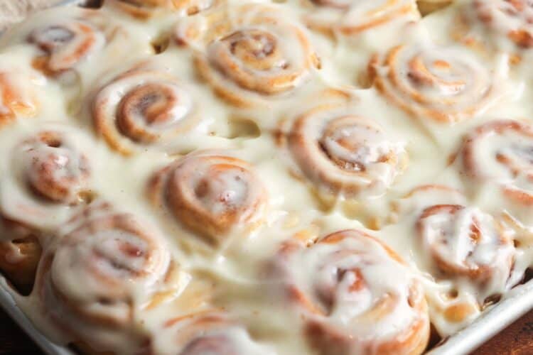 closeup of mini cinnamon rolls loaded with cream cheese frosting.