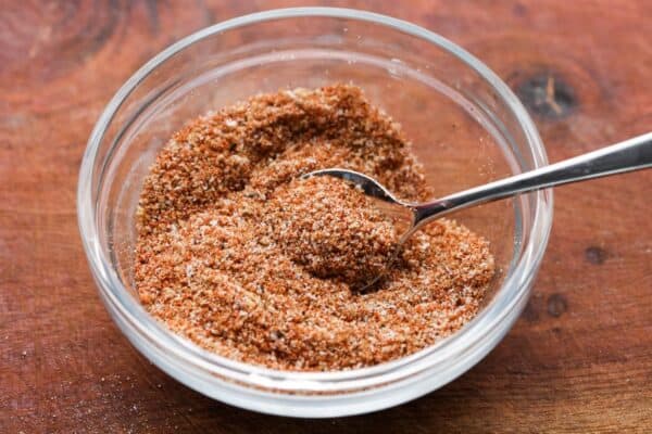 spice rub for brisket in a small glass bowl with a teaspoon in it.