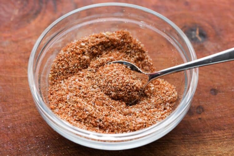 spice rub for brisket in a small glass bowl with a teaspoon in it.