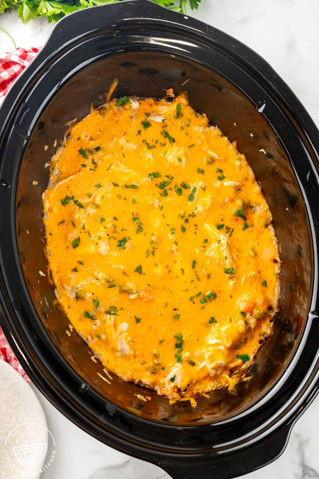 slow cooker chicken and rice in a black crock pot, viewed from above.