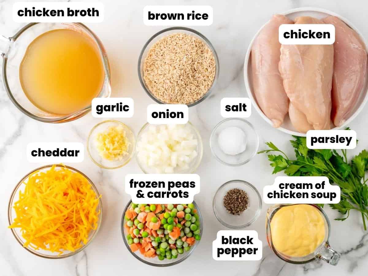 Ingredients for making slow cooker chicken breasts with brown rice, frozen veggies, and cheese.