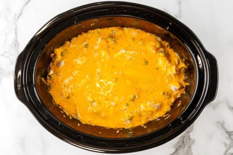 melted cheese over chicken rice casserole in a crock pot.