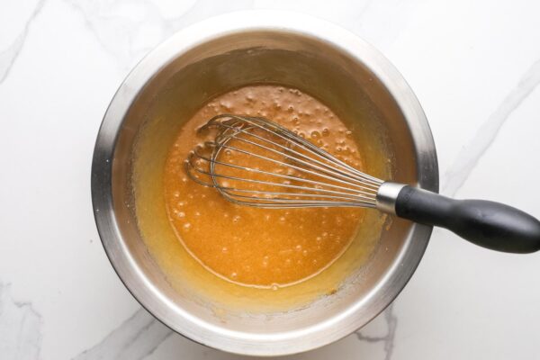 melted butter whisked with brown sugar in a metal bowl.