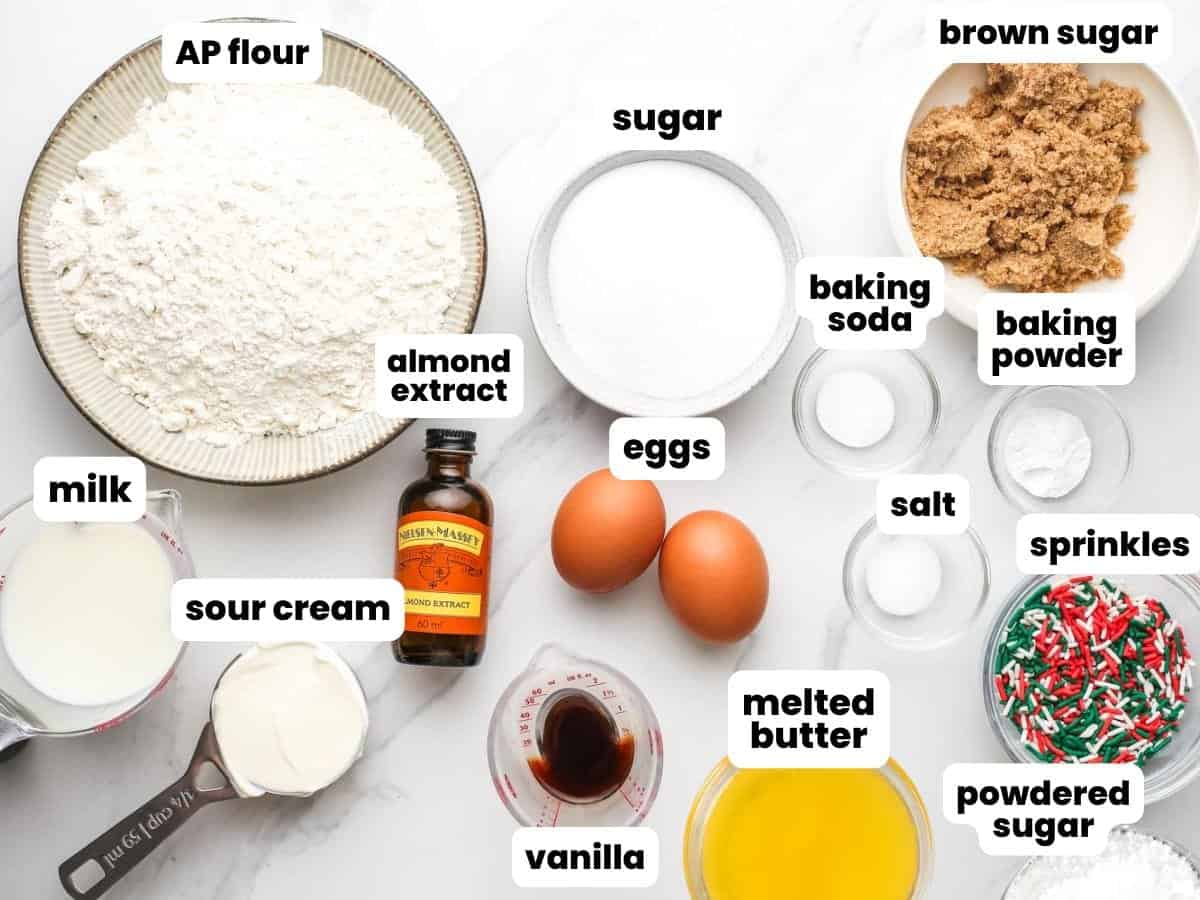 Ingredients for making christmas quick bread with sprinkles and almond extract.
