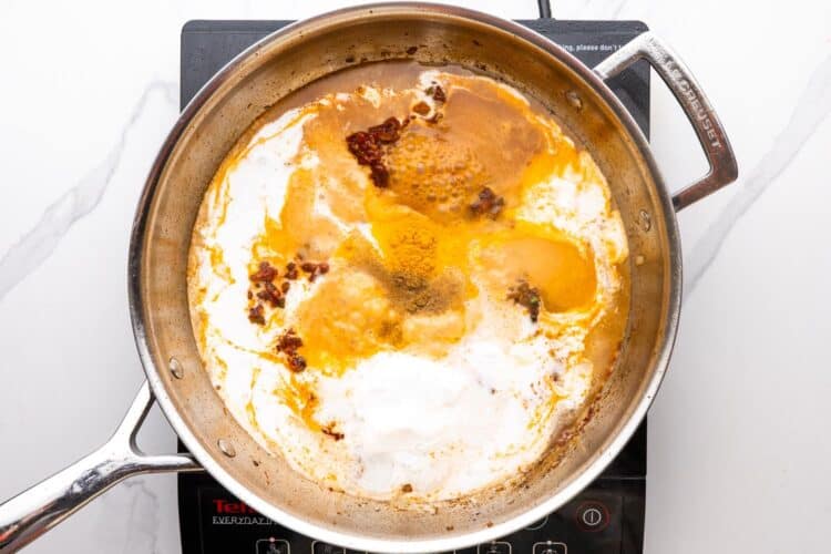 cream added to a pan to create a coconut sauce.