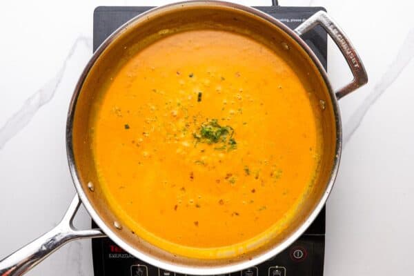 creamy coconut milk sauce in a stainless steel skillet.