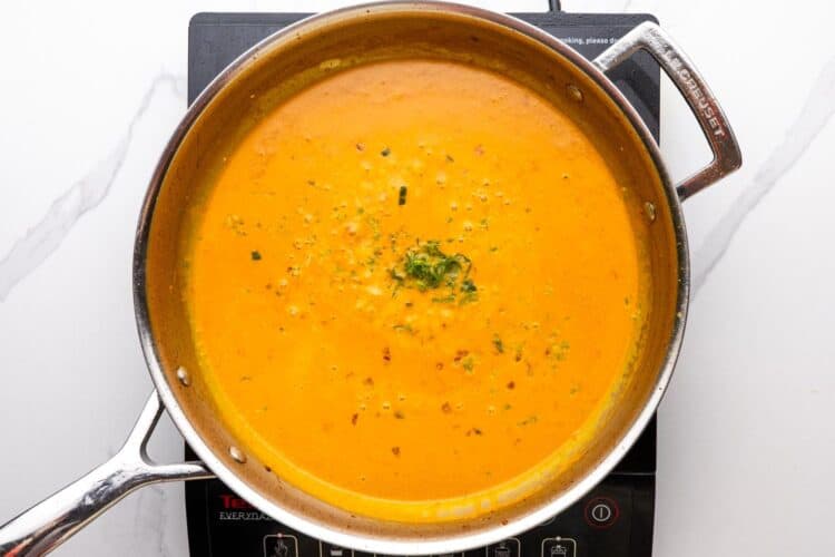 creamy coconut milk sauce in a stainless steel skillet.