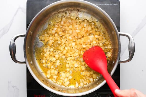 diced onion sauteed in butter and oil in a stainless steel dutch oven.