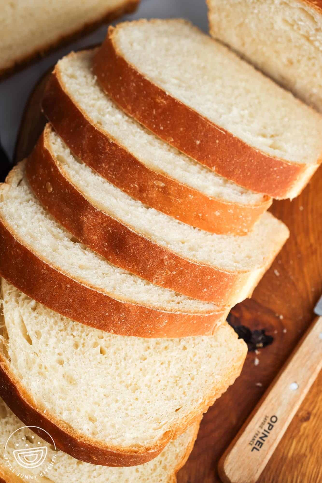 Overhead shot of sliced sandwich bread on a wooden board