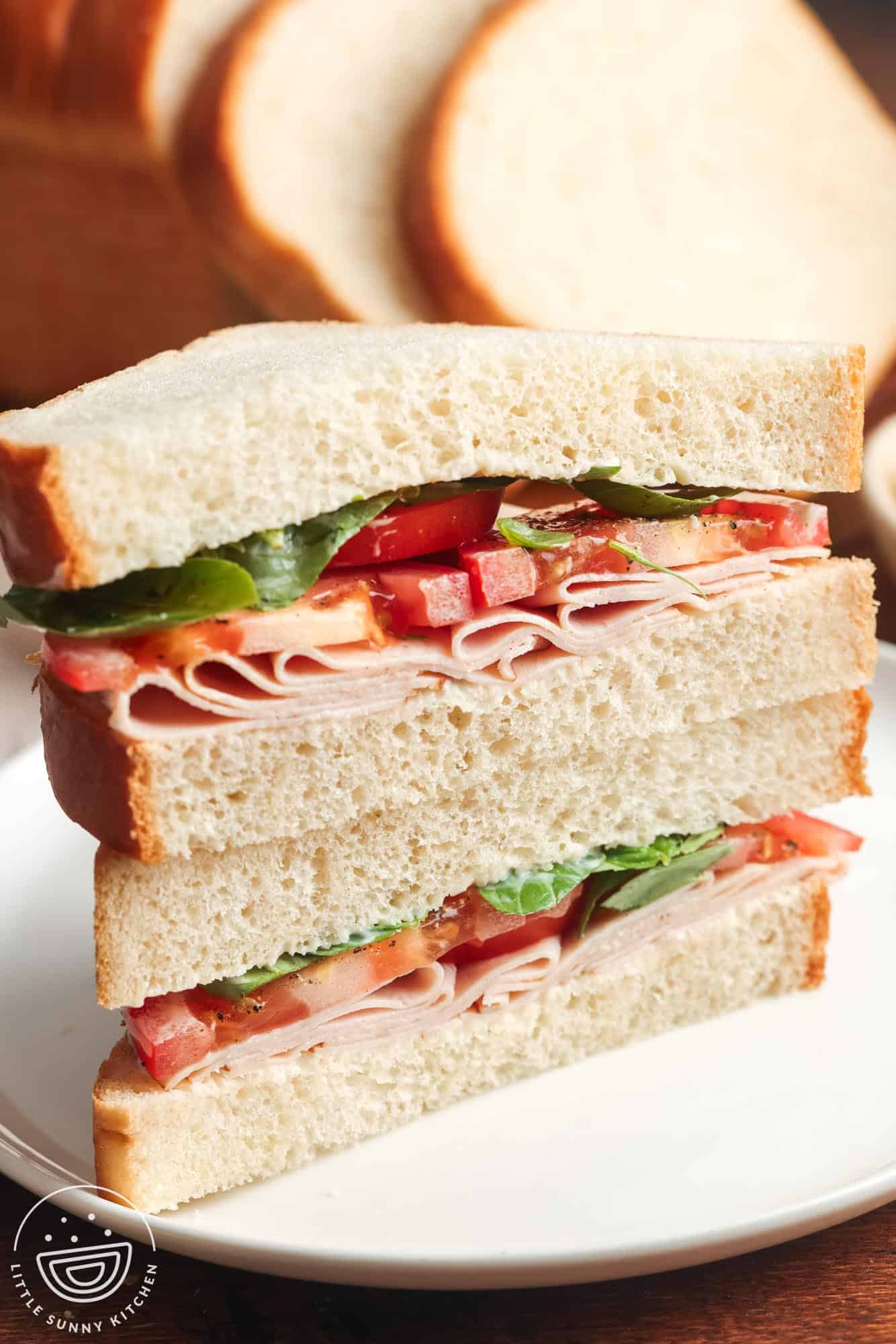 Turkey sandwich using white toast, with lettuce and tomatoes