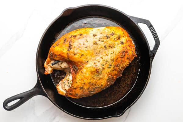 slow cooker turkey breast transferred to a cast iron skillet, has been in the oven to brown the skin.