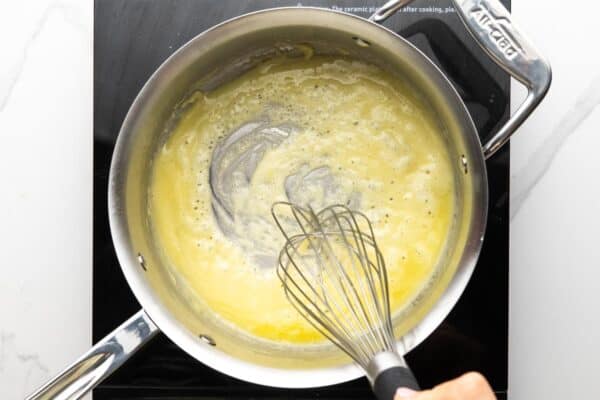 butter and flour cooking in a saucepan, stirred with a whisk.