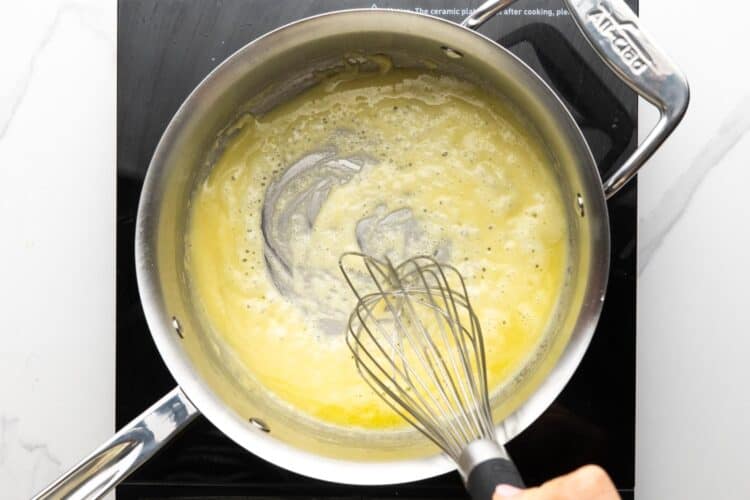 butter and flour cooking in a saucepan, stirred with a whisk.