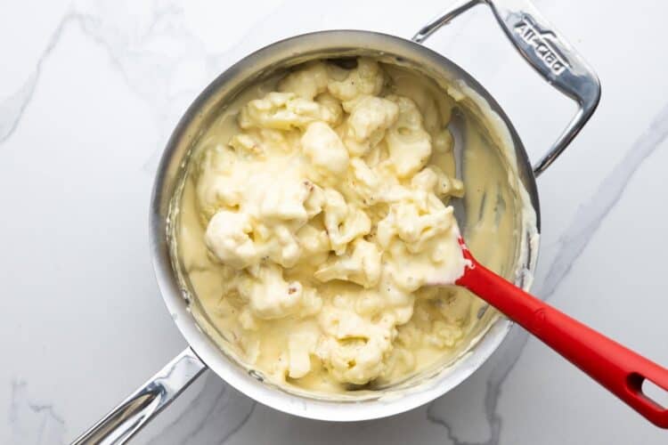 roasted cauliflower florets stirred into a pan of creamy cheese sauce.